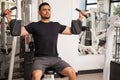 Handsome man on a pec deck machine Royalty Free Stock Photo