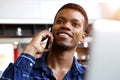 Handsome man on phone call in cafe with laptop Royalty Free Stock Photo