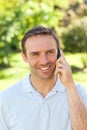 Handsome man phoning in the park Royalty Free Stock Photo