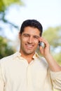 Handsome man phoning in the park Royalty Free Stock Photo