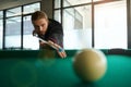 Snooker player placing the cue ball for shot indoors Royalty Free Stock Photo