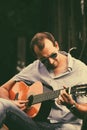 Handsome man playing acoustic guitar