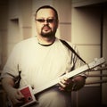 Handsome man playing his cigar box guitar Royalty Free Stock Photo