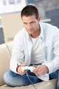 Handsome man playing video game at home smiling Royalty Free Stock Photo