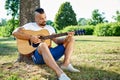 Handsome man plying guitar outdoor Royalty Free Stock Photo