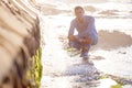 Handsome man, portrait and beach with water in relax for summer holiday, weekend or enjoying day by the sea. Young male Royalty Free Stock Photo