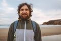 Handsome man portrait curly hair outdoor bearded guy with backpack travel lifestyle Royalty Free Stock Photo