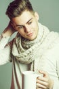 Handsome guy with cup in scarf