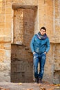Handsome man posing against grunge ruins. Royalty Free Stock Photo