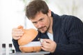 handsome man pouring essential oil in diffuser