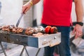 Handsome man preparing barbecue for friends.Hand of young man grilling some meat and vegetable. Royalty Free Stock Photo