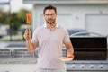 Handsome man preparing barbecue. Male cook cooking salmon fish on barbecue grill. Guy cooking meat on barbecue for Royalty Free Stock Photo