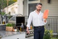 Handsome man preparing salmon fillet on barbecue. Male cook cooking fish on barbecue grill. Guy cooking on barbecue for Royalty Free Stock Photo