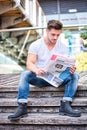 Handsome man reading newspaper outdoor in city Royalty Free Stock Photo