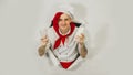 A handsome man with red dreadlocks holds it in his hand milk. Confident young cook in white apron and red tie holding a Royalty Free Stock Photo