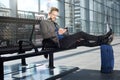 Handsome man relaxing at airport with mobile phone Royalty Free Stock Photo