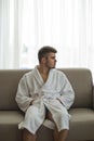 Handsome man relaxing in bathrobe