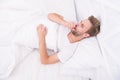 Handsome man relaxing in bed. Snoring can increase risk headaches. Common symptom of sleep apnea. Causes of early