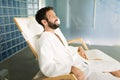 Handsome man relaxing in chair at spa center Royalty Free Stock Photo