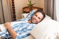 Handsome man relaxing on his bed reading magazine Royalty Free Stock Photo