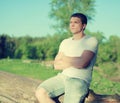 Handsome man relaxing on a nature, soft sunny sunset Royalty Free Stock Photo