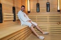 Man relaxing in sauna and staying healthy