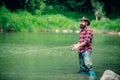 Handsome man relaxing. Summer weekends or vacation. United with nature. Fishing by the lake. Summer weekend. Fly fish Royalty Free Stock Photo