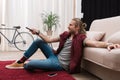 handsome man with remote control watching tv