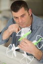 handsome man repairing drone with screwdriver Royalty Free Stock Photo
