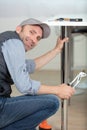 Handsome man repairing table with tools Royalty Free Stock Photo