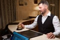 Handsome man ringing service bell at reception desk in the hotel lobby Royalty Free Stock Photo