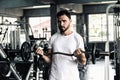 Handsome Man is Rowing Exercise With Bodybuilder Equipment in Fitness Club.,Portrait of Strong Man doing Working Out Calories