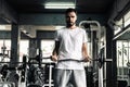 Handsome man is rowing exercise with bodybuilder equipment in fitness club.,Portrait of strong man doing working out calories