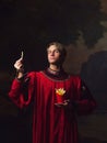 Handsome man in a Royal red doublet eating French fries.