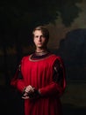 Handsome man in a Royal red doublet.