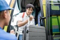 A handsome man with rucksack and suitcase walking out from travel bus Royalty Free Stock Photo