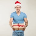 Handsome man in santa hat - hand gift box Royalty Free Stock Photo