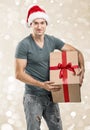 Handsome man in santa hat - hand gift box