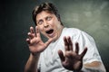 Handsome man scared over dark grey Royalty Free Stock Photo