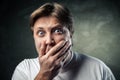 Handsome man scared over dark grey Royalty Free Stock Photo