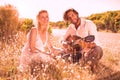 Handsome man serenading his girlfriend with guitar