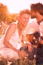 Handsome man serenading his girlfriend with guitar