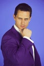 Handsome man with serious face posing in violet suit jacket Royalty Free Stock Photo