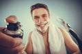 Handsome man with shaving cream foam can and razor Royalty Free Stock Photo