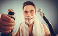 Handsome man with shaving cream foam can and razor Royalty Free Stock Photo