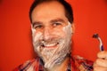 Handsome man with shaving foam on his face and razor Royalty Free Stock Photo