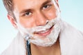 Handsome man shaving with razor Royalty Free Stock Photo