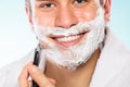 Handsome man shaving with razor Royalty Free Stock Photo