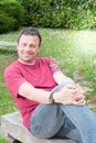 handsome man sit on bench garden on summer Royalty Free Stock Photo