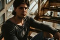 Handsome man sitting alone on the staircase and thinking Royalty Free Stock Photo